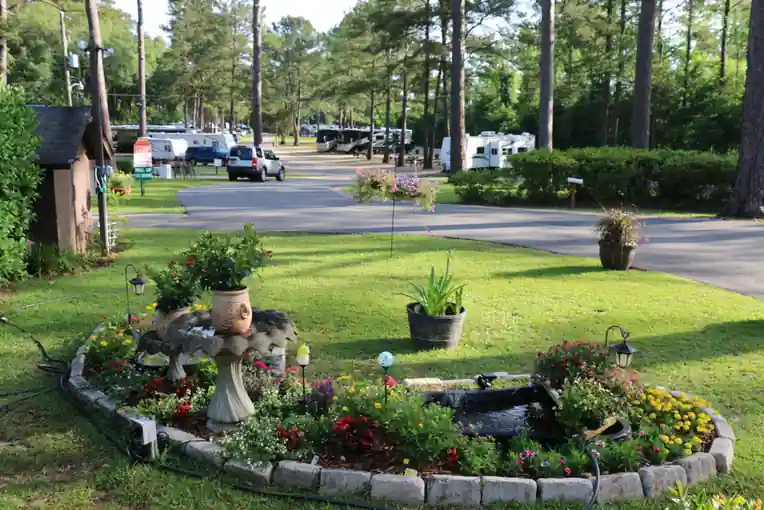 Stone-edged flower island and pond on the park road