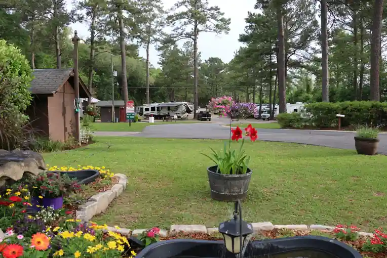 Pond-side garden of flowers with RV sites behind